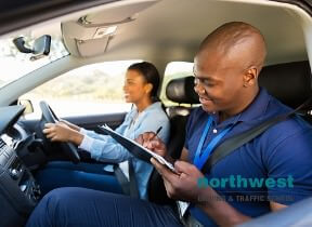 girl taking driving lesson