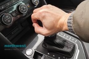 driver holds gear lever of car